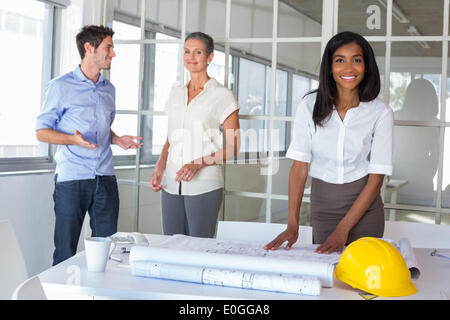 Workers looking at construction plans Stock Photo