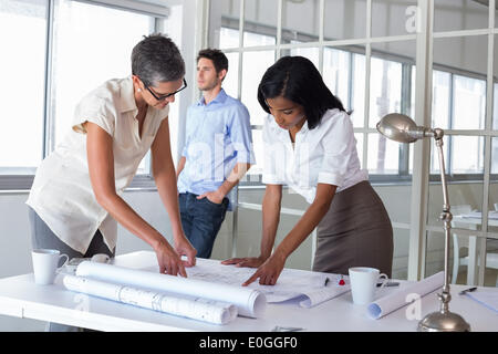 Two architects looking at blueprints Stock Photo