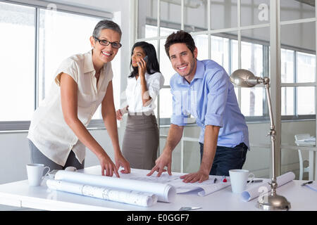 Attractive architects going over plans Stock Photo