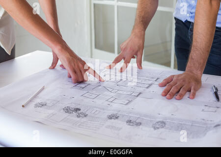 Architects working on blueprints together Stock Photo