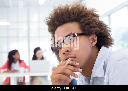 Attractive businessman wearing glasses and thinking Stock Photo