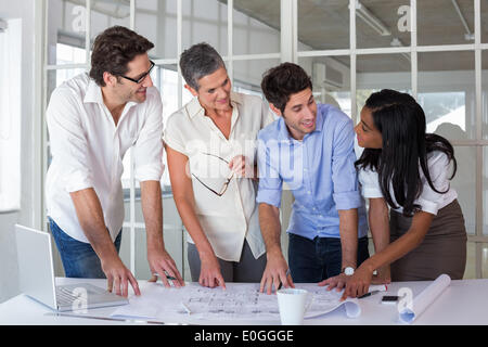 Team of architects going over blueprints Stock Photo