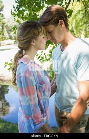 Close young couple standing together in the park Stock Photo