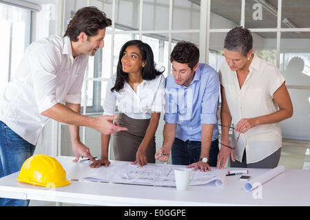 Team of architects going over blueprints Stock Photo