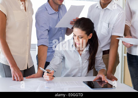 Attractive businesswoman working with businessmen Stock Photo