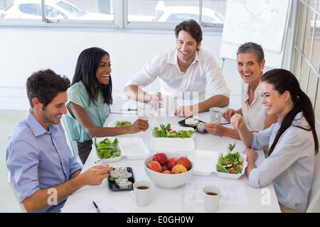 Workers laughing while enjoying lunch break Stock Photo