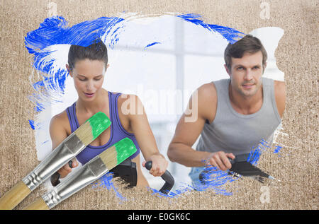 Composite image of couple working out in gym Stock Photo