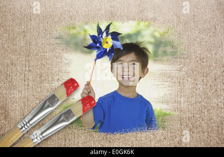 Composite image of little boy with pinwheel Stock Photo