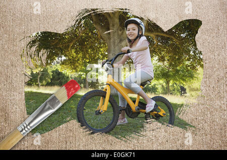 Composite image of little girl on a bike Stock Photo