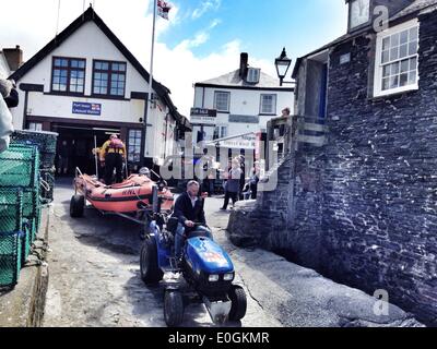 Port Isaac, Cornwall, UK. 13th May, 2014. The Port Isaac RNLI lifeboat launched about 1PM. They have been requested to assist the Coast Guard search for a missing person near Bossiney, Tintagel, Cornwall. Please note: Images taken with mbile phone. Credit:  nidpor/Alamy Live News Stock Photo
