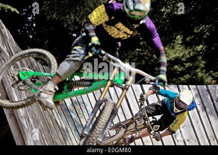 Two freeride mountain bikers in wallride, Chatel, Portes du Soleil, Haute-Savoie, France Stock Photo