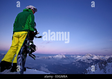 Snowboarder standing on the top of a mountain, Hahnenkamm, Tyrol, Austria Stock Photo