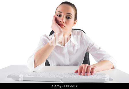 Bored businesswoman typing on keyboard on white background Stock Photo ...
