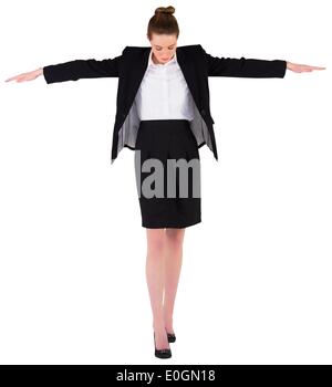 Businesswoman performing a balancing act Stock Photo
