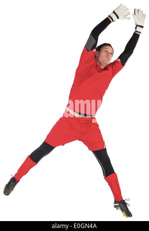 Fit goal keeper jumping up Stock Photo