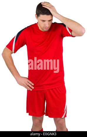 Disappointed football player looking down Stock Photo