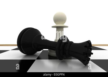 White pawn standing over fallen black queen Stock Photo