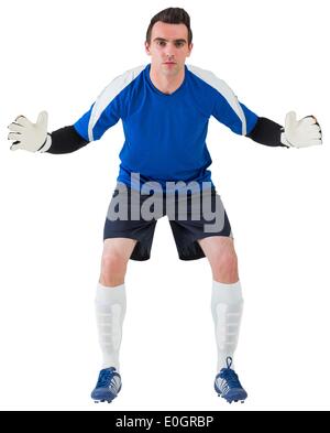 Goalkeeper in blue ready to save Stock Photo