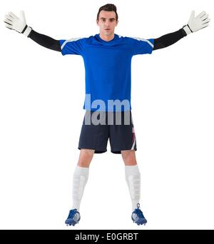 Goalkeeper in blue ready to save Stock Photo