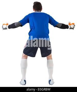 Goalkeeper in blue ready to save Stock Photo