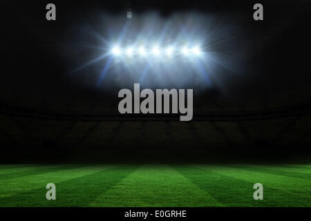 Football pitch under spotlights Stock Photo