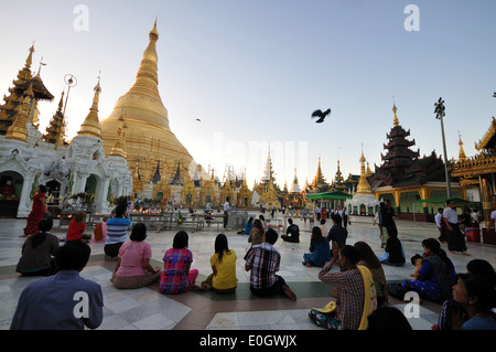 People praying in front of the Shwedagon Pagoda, Yangon, Myanmar, Burma, Asia Stock Photo