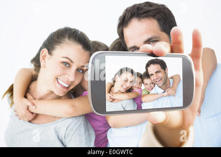 Composite image of hand holding smartphone showing Stock Photo