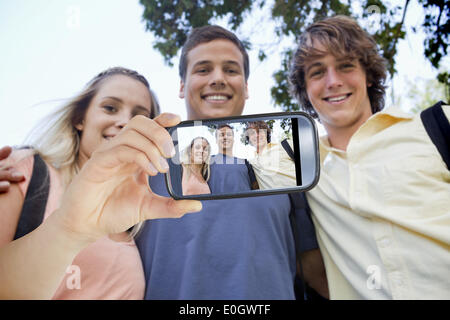 Composite image of hand holding smartphone showing Stock Photo
