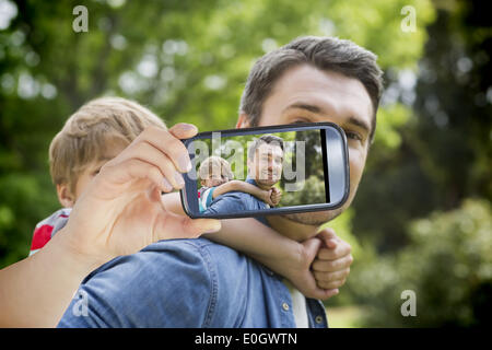 Composite image of hand holding smartphone showing Stock Photo