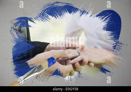 Composite image of groom placing ring on brides finger Stock Photo