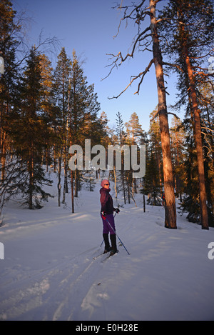 Young woman practicing Altai Skiing in Pyhä ski resort, Lapland, Finland Stock Photo