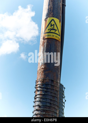 Danger of death sign on electricity pole UK Stock Photo