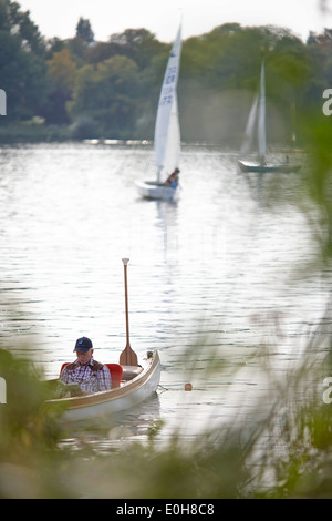 Canoe and sailing boats on the Inner Alster lake, Binnenalster, East bank, Hamburg, Germany Stock Photo