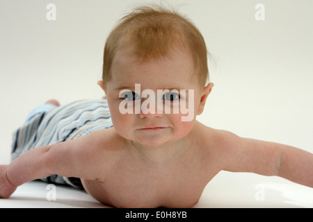 12 TWELVE MONTH OLD BABY BOY LEARNING TO CRAWL Stock Photo