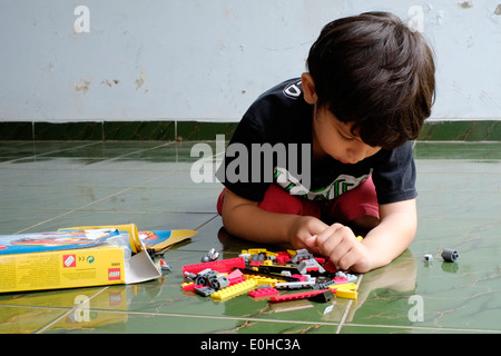 little boy playing with lego Stock Photo