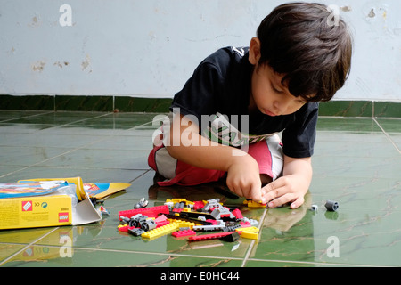 little boy playing with lego Stock Photo