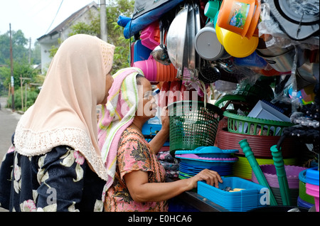 locals in a rural village in east java indonesia gather around a truck selling pots and pans and general cheap household goods Stock Photo