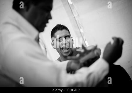 (140514) -- MEXICO CITY, May 14, 2014 (Xinhua) -- Federal policeman Francisco Javier Ruiz Garcia (R) prepares for his participation in the First Tournament of Boxing for Policemen which is organized by the World Boxing Council and the National Sports Commission (CONADE, for its acronym in Spanish) at the command center of Federal Police of Mexico, in Mexico City, capital of Mexico, on May 13, 2014. At least 160 members of the Federal Police, Secretary of National Defense (SEDENA, for its acronym in Spanish), Secretary of Marine (SEMAR, for its acronym in Spanish), and state and municipal poli Stock Photo