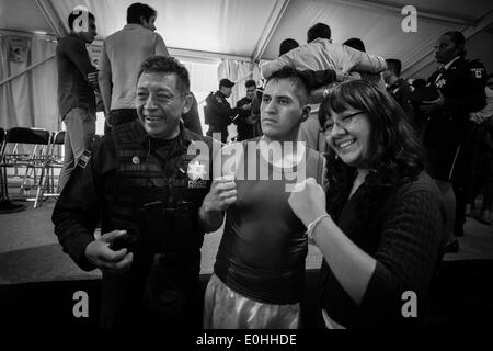 (140514) -- MEXICO CITY, May 14, 2014 (Xinhua) -- Federal policeman Francisco Javier Ruiz Garcia poses with supporters after wining the fight against the marine Luis Felipe 'El Choco' Garcia in knockout during the First Tournament of Boxing for Policemen which is organized by the World Boxing Council and the National Sports Commission (CONADE, for its acronym in Spanish) at the command center of Federal Police of Mexico, in Mexico City, capital of Mexico, on May 13, 2014. At least 160 members of the Federal Police, Secretary of National Defense (SEDENA, for its acronym in Spanish), Secretary Stock Photo