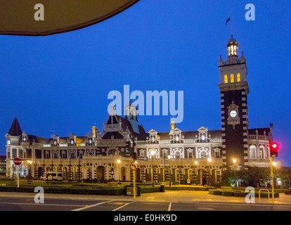 Dunedin Railway Station with clocktower clock tower at night on Anzac Square. The most photographed building in New Zealand. Stock Photo