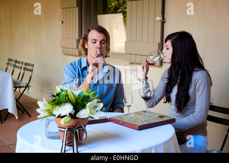 Attractive young couple at a wine tasting outdoors in Franschhoek, South Africa Stock Photo