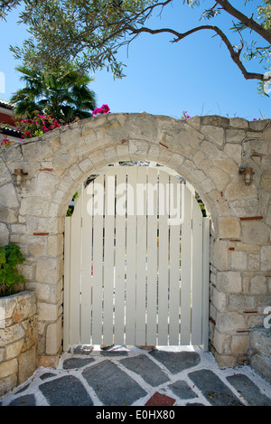Wooden gate in a stone built wall Stock Photo