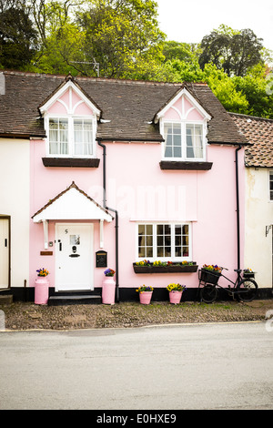 A pink painted cottage house in the picturesque village of Dunster, Devon, England Stock Photo