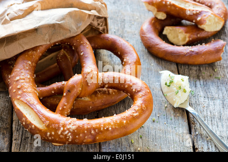 Fresh baked pretzel and cream cheese.Selective focus on the pretzel Stock Photo