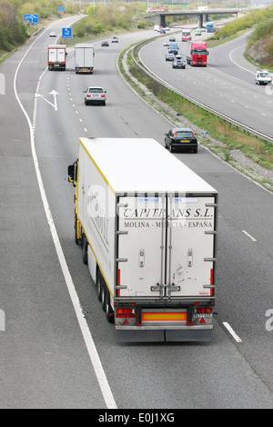 Trucks and other traffic traveling along the M20 motorway in Kent, England. Stock Photo