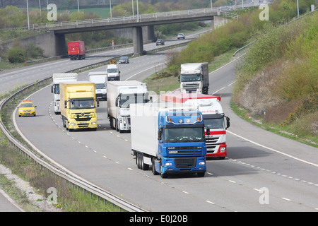 Trucks and other trafic traveling along the M20 motorway in Kent, England. Stock Photo