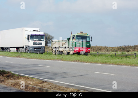 Two trucks traveling on the A417 dual carriageway in The Cotswolds, England. Stock Photo