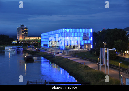 The Lentos Art Museum, located on the Danube River,  li up at night with blue lighting. Stock Photo