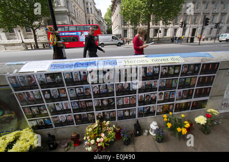 Westminster London UK. 14th May 2014. A shrine with the pictures and names of the victims of the Euromaidan protest in Ukraine is placed on a wall opposite Downing Street. The Euromaidan civil unrest  began in 21 November 2013 that resulted in the toppling of Ukrainian President Viktor Yanukovytch and the death of many protesters Credit:  amer ghazzal/Alamy Live News Stock Photo