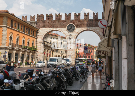 Busy street in Verona with Portoni della Bra, medieval gate leading to the Piazza Bra in historic city center. Stock Photo